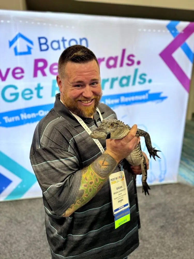 Brian Zahringer of BugBoss holding a young alligator — BugBoss handles the wildlife work most rural pest companies won't
