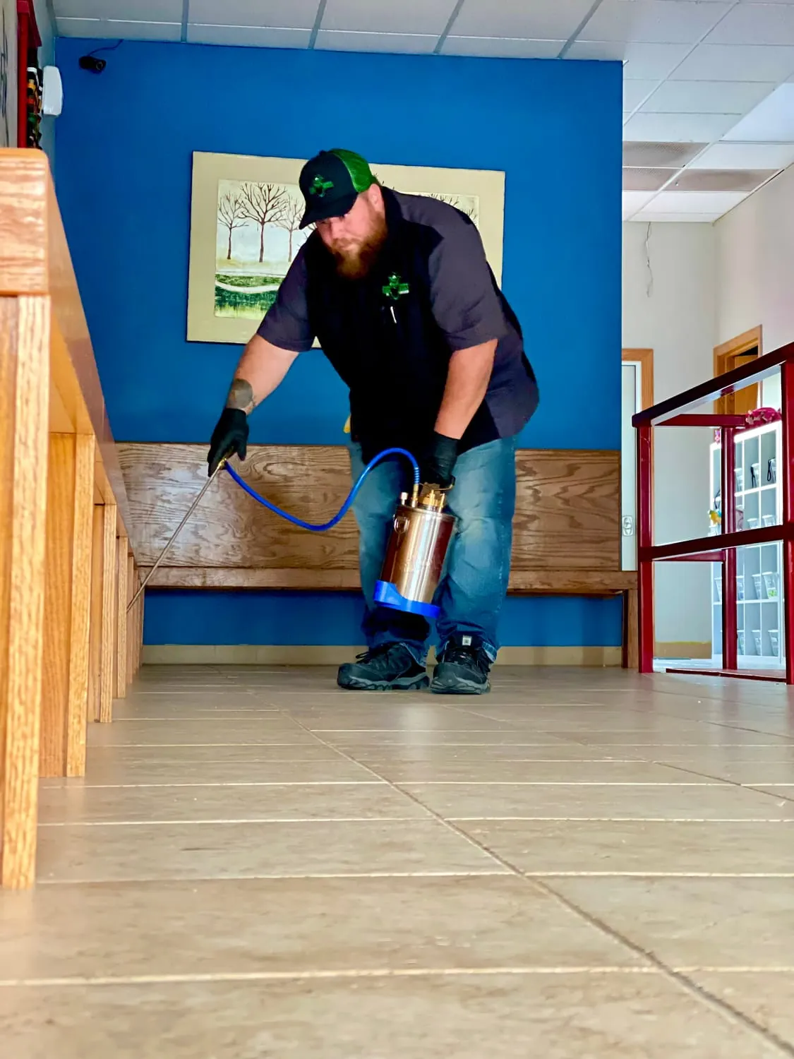BugBoss treating interior baseboards during a residential pest control visit